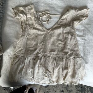 Cream-colored blouse with a tie in the back